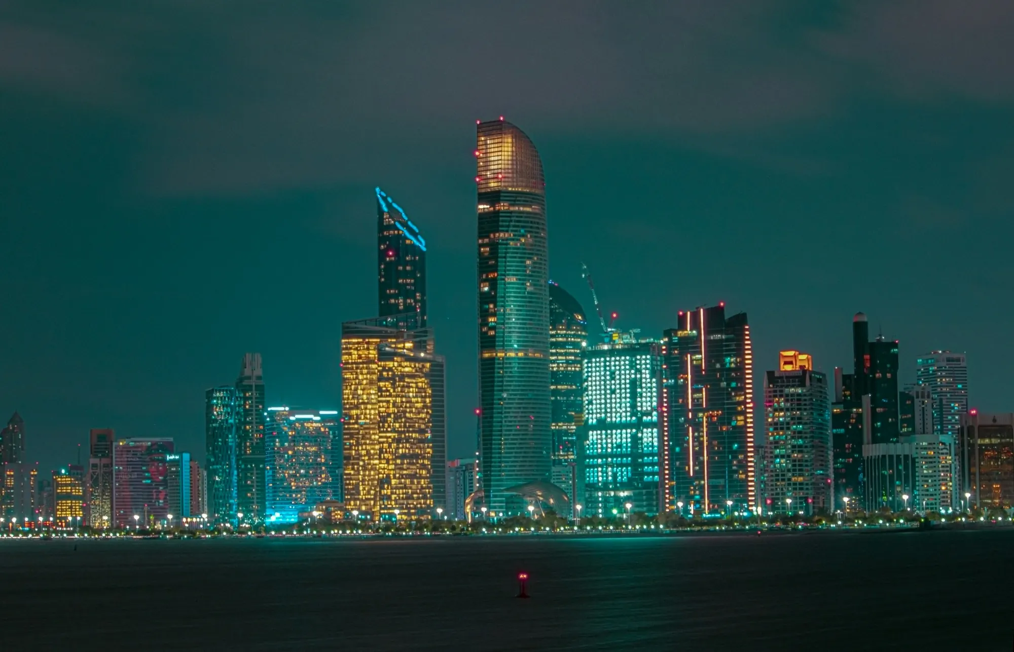 Abu Dhabi skyline at night across the water